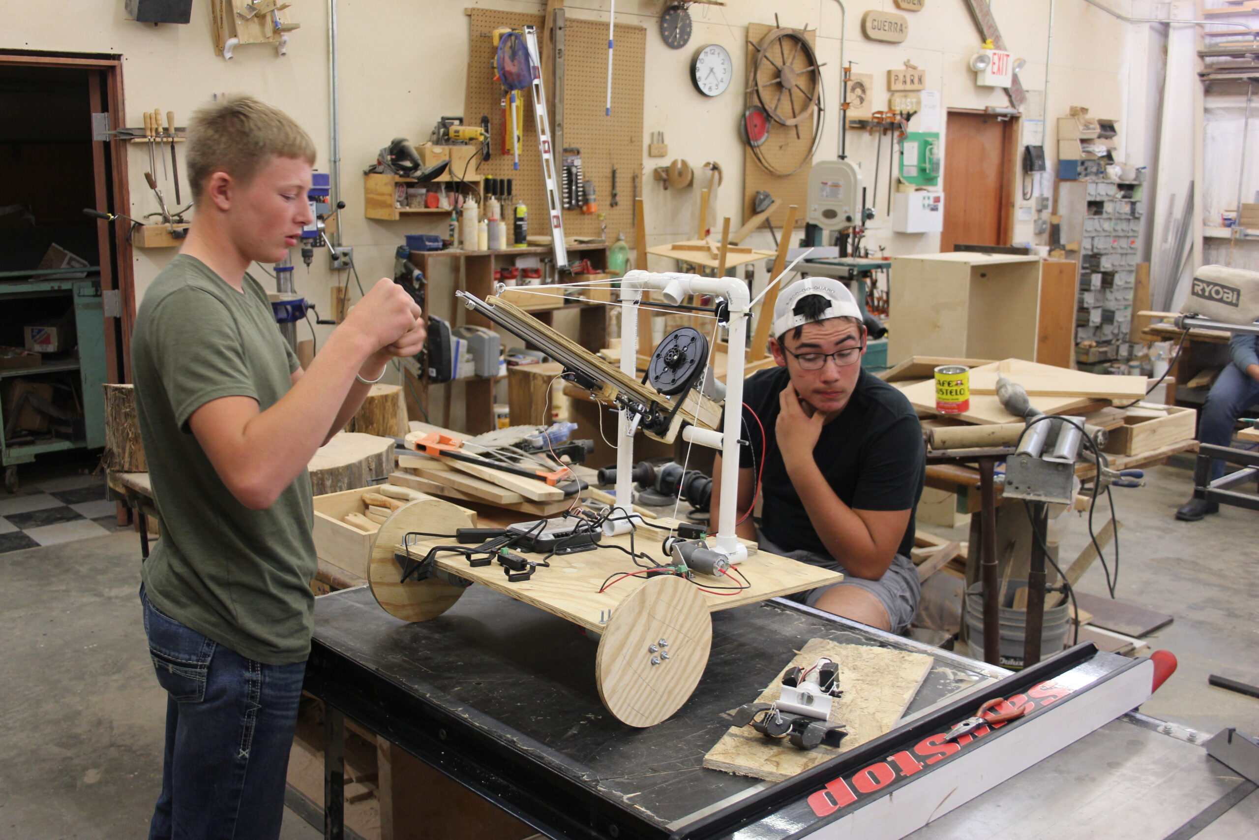Two Sunshine Bible Academy students working on a hands-on project in the industrial arts woodworking shop